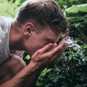 man washing his face as patt of his skincare routine